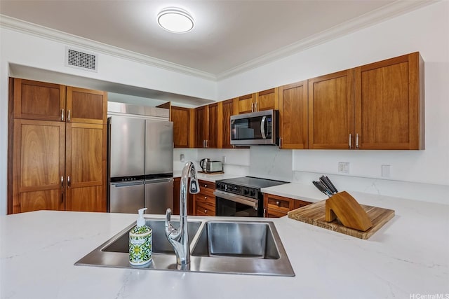 92-1087 Koio Drive M29-3 (Apt C), Kapolei, HI 96707 - kitchen featuring appliances with stainless steel finishes, crown molding, brown cabinetry, and light stone countertops