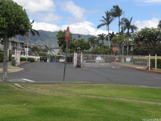 94-542 Kupuohi St Unit 103, Waipahu, HI 96797 - view of asphalt street with traffic signs, a mountain view, and curbs