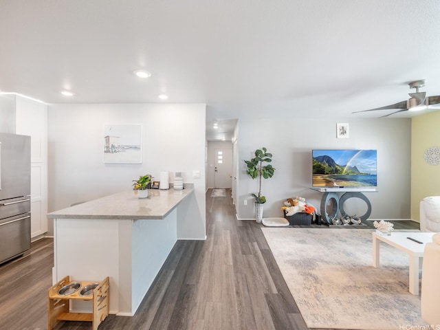 91-1348 Kakiwi St, Ewa Beach, HI 96706 - kitchen with a peninsula, dark wood-type flooring, recessed lighting, white cabinets, and a ceiling fan