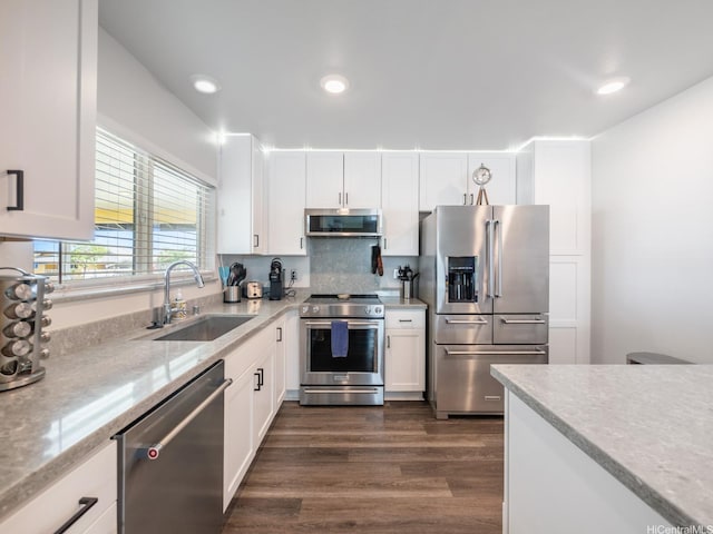91-1348 Kakiwi St, Ewa Beach, HI 96706 - kitchen with high quality appliances, white cabinetry, dark wood-type flooring, recessed lighting, and light stone countertops