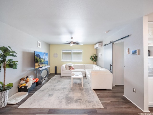 91-1348 Kakiwi St, Ewa Beach, HI 96706 - living room featuring a barn door, a wall mounted AC, ceiling fan, and dark wood finished floors
