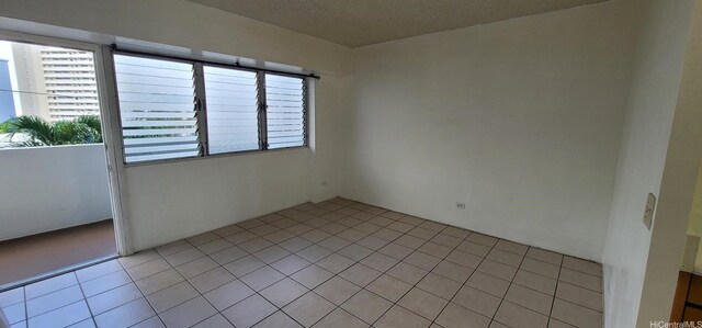 1516 Ward Ave Unit 207, Honolulu, HI 96822 - empty room with light tile patterned floors and a textured ceiling