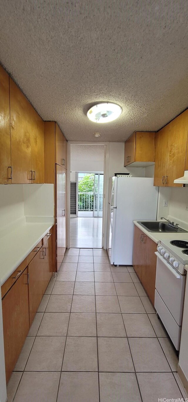 1516 Ward Ave Unit 207, Honolulu, HI 96822 - kitchen featuring white appliances, ventilation hood, a textured ceiling, light countertops, and light tile patterned floors