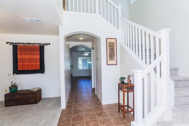 91-1073 Kaianae St, Ewa Beach, HI 96706 - corridor with arched walkways, stairs, and dark tile patterned floors