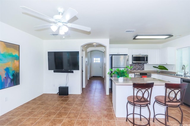 91-1073 Kaianae St, Ewa Beach, HI 96706 - kitchen featuring appliances with stainless steel finishes, healthy amount of natural light, ceiling fan, and arched walkways
