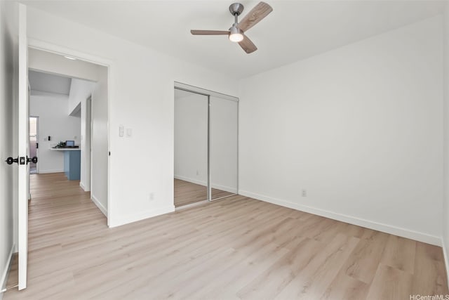 94-431 Keaoopua St Unit 104, Mililani, HI 96789 - unfurnished bedroom with light wood-style floors, a closet, and ceiling fan