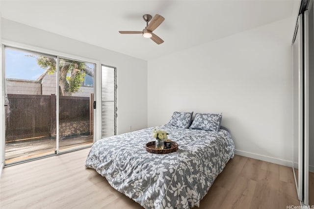 94-431 Keaoopua St Unit 104, Mililani, HI 96789 - bedroom with wood finished floors, access to exterior, and a ceiling fan