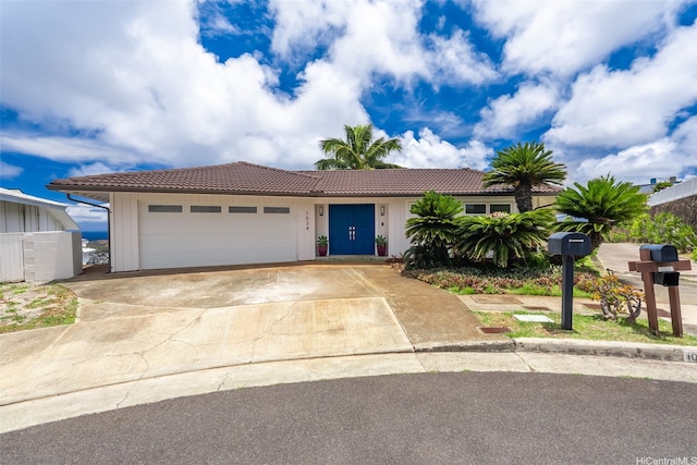 1034 Kaumoku St, Honolulu, HI 96825 - ranch-style home with a tile roof, a garage, and driveway
