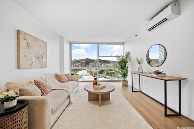 909 Kapiolani Blvd Unit 2305, Honolulu, HI 96814 - living area featuring a wall unit AC, wood finished floors, plenty of natural light, and a wall of windows