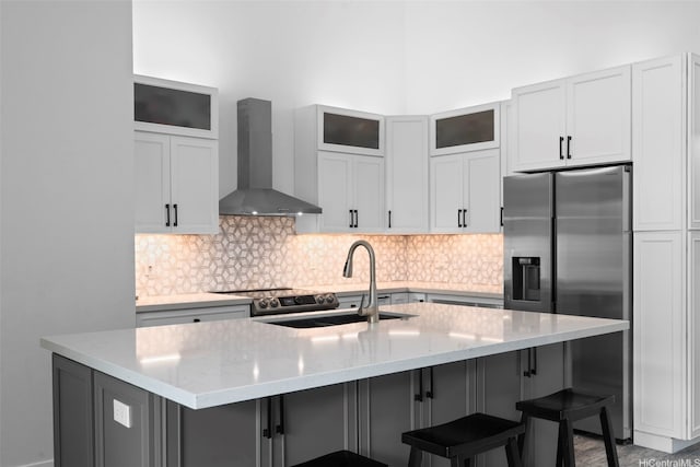 7780 Waikapu Loop, Honolulu, HI 96825 - kitchen with wall chimney exhaust hood, appliances with stainless steel finishes, decorative backsplash, a breakfast bar area, and glass insert cabinets