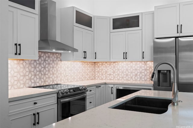 7780 Waikapu Loop, Honolulu, HI 96825 - kitchen featuring wall chimney range hood, appliances with stainless steel finishes, light stone countertops, and decorative backsplash