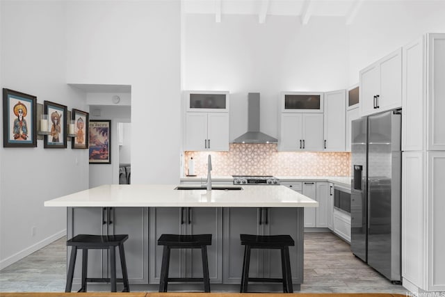 7780 Waikapu Loop, Honolulu, HI 96825 - kitchen with wall chimney exhaust hood, appliances with stainless steel finishes, a high ceiling, tasteful backsplash, and a kitchen breakfast bar