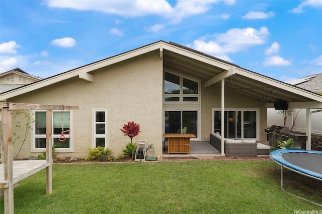 7780 Waikapu Loop, Honolulu, HI 96825 - back of property featuring stucco siding, a trampoline, a yard, and a patio