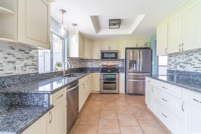 1335 Onioni St, Kailua, HI 96734 - kitchen featuring stainless steel appliances, cream cabinetry, a tray ceiling, decorative backsplash, and dark stone counters