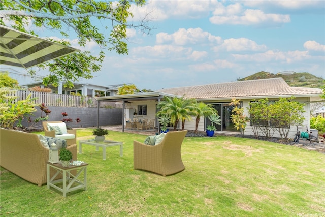 1335 Onioni St, Kailua, HI 96734 - fenced backyard featuring a patio area, an outdoor living space, and a ceiling fan
