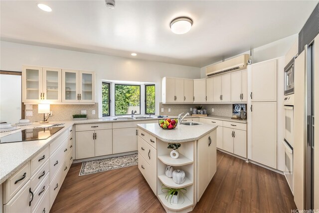 5926 Kalanianaole Hwy, Honolulu, HI 96821 - kitchen with a wall unit AC, tasteful backsplash, open shelves, recessed lighting, and dark wood-type flooring