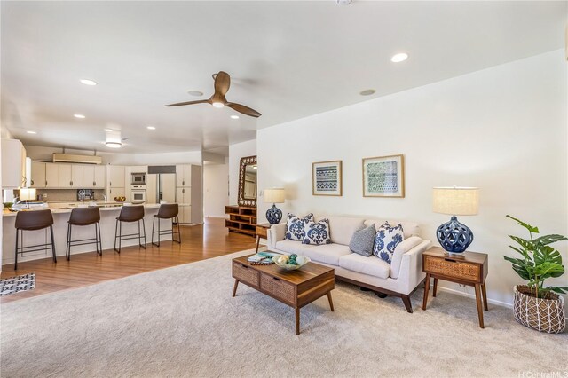 5926 Kalanianaole Hwy, Honolulu, HI 96821 - living room featuring light colored carpet, ceiling fan, recessed lighting, and light wood-style flooring