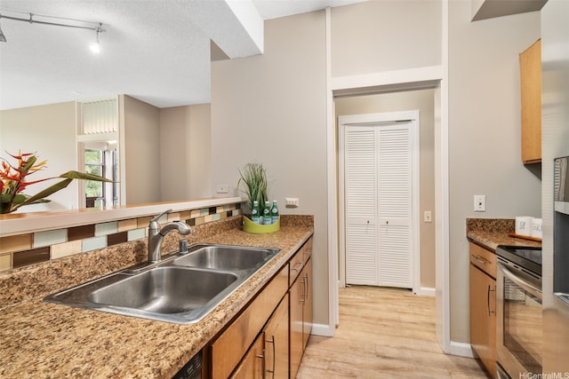 1020 Aoloa Pl Unit 311B, Kailua, HI 96734 - kitchen with stainless steel electric stove, light wood finished floors, and brown cabinets