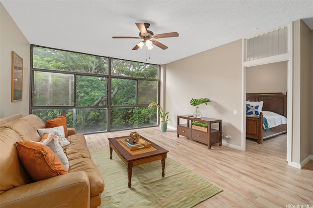 1020 Aoloa Pl Unit 311B, Kailua, HI 96734 - living room featuring expansive windows, a ceiling fan, plenty of natural light, and light wood-type flooring