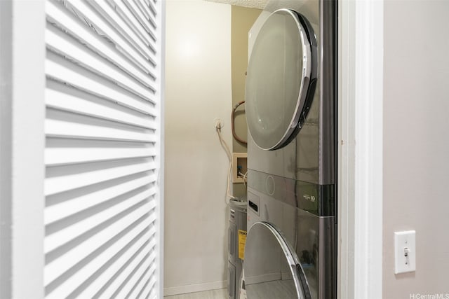 1020 Aoloa Pl Unit 311B, Kailua, HI 96734 - washroom featuring stacked washer / dryer and baseboards