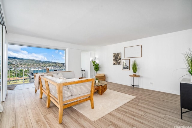 2575 Kuhio Ave Unit 1702, Honolulu, HI 96815 - living room featuring light wood-style floors and baseboards