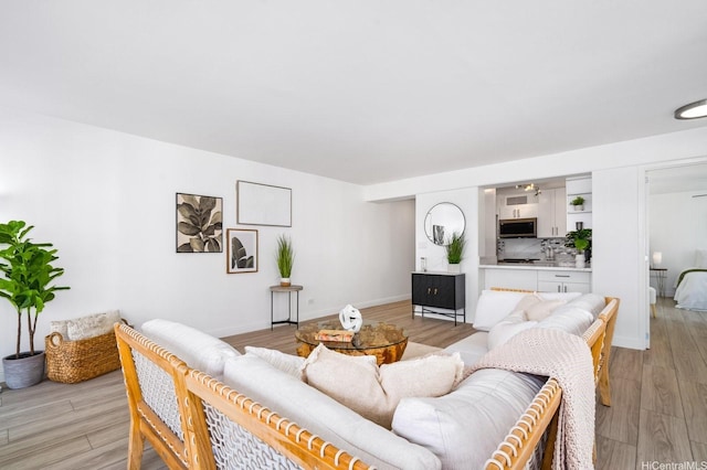 2575 Kuhio Ave Unit 1702, Honolulu, HI 96815 - living room with light wood-style floors and baseboards