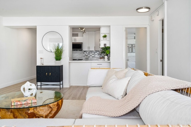 2575 Kuhio Ave Unit 1702, Honolulu, HI 96815 - living area with light wood-style flooring and baseboards