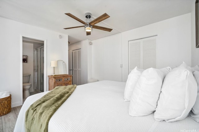 2575 Kuhio Ave Unit 1702, Honolulu, HI 96815 - bedroom with wood finished floors, connected bathroom, and a ceiling fan