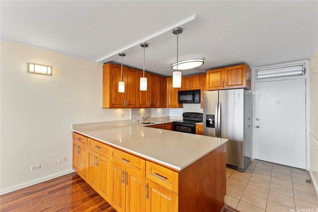 46-255 Kahuhipa St Unit A1100, Kaneohe, HI 96744 - kitchen with black appliances, a peninsula, light countertops, and brown cabinetry