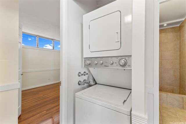 46-255 Kahuhipa St Unit A1100, Kaneohe, HI 96744 - washroom featuring stacked washer and clothes dryer and wood finished floors