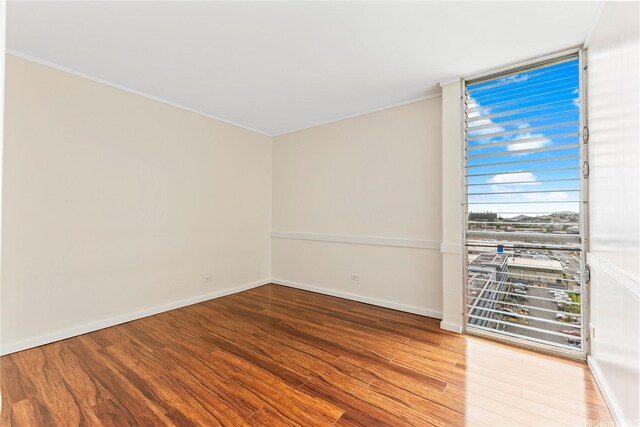 46-255 Kahuhipa St Unit A1100, Kaneohe, HI 96744 - spare room with wood finished floors and crown molding