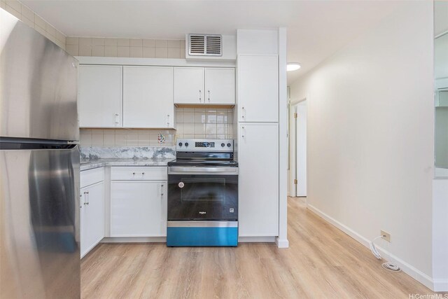402 Iolani Ave Unit 204, Honolulu, HI 96813 - kitchen featuring appliances with stainless steel finishes, light wood finished floors, white cabinetry, and tasteful backsplash