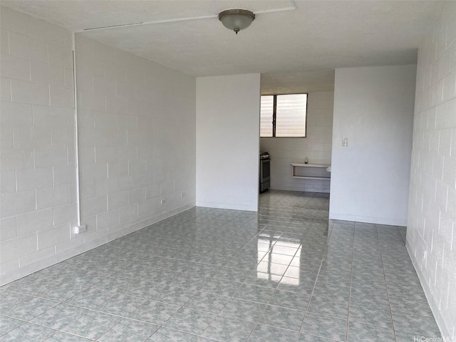 1118 Pua Ln Unit 113, Honolulu, HI 96817 - empty room with concrete block wall and tile patterned floors