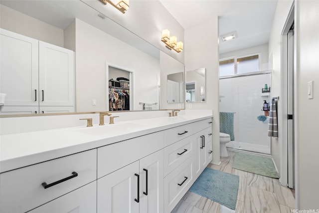91-1542 Fort Weaver Rd, Ewa Beach, HI 96706 - bathroom featuring double vanity, a stall shower, marble finish floors, and a spacious closet