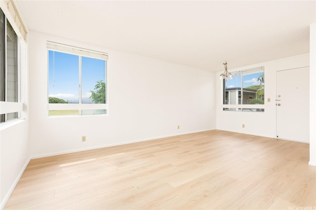 95-670 Hanile St Unit A202, Mililani, HI 96789 - unfurnished room featuring light wood-type flooring and a chandelier