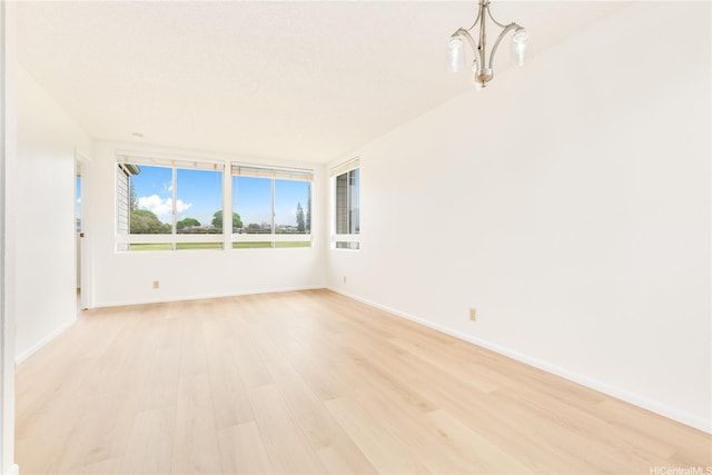 95-670 Hanile St Unit A202, Mililani, HI 96789 - empty room featuring light wood-style flooring and a chandelier