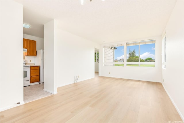 95-670 Hanile St Unit A202, Mililani, HI 96789 - unfurnished living room with light wood-style flooring and baseboards