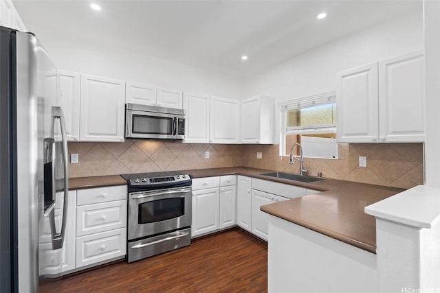 91-2131 Kaioli St Unit 3405, Ewa Beach, HI 96706 - kitchen with appliances with stainless steel finishes, a peninsula, white cabinets, dark wood-type flooring, and recessed lighting