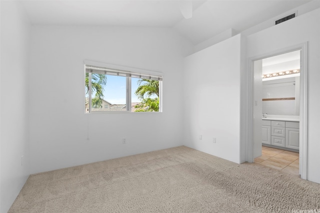 91-2131 Kaioli St Unit 3405, Ewa Beach, HI 96706 - unfurnished bedroom with light colored carpet, vaulted ceiling, and connected bathroom