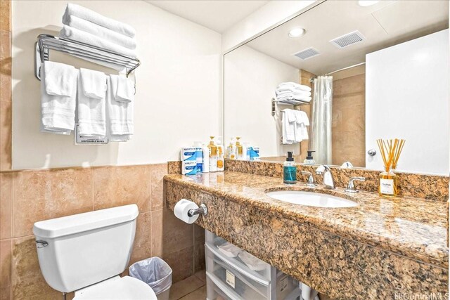 1850 Ala Moana Blvd Unit 1107, Honolulu, HI 96815 - bathroom with vanity, a shower with curtain, tile walls, wainscoting, and recessed lighting