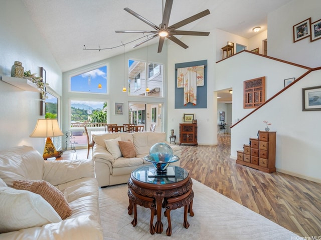 1586 Paukiki St, Kailua, HI 96734 - living area with a ceiling fan, wood finished floors, high vaulted ceiling, and stairway