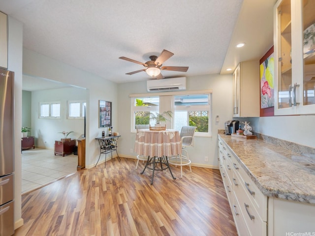 1586 Paukiki St, Kailua, HI 96734 - kitchen featuring an AC wall unit, healthy amount of natural light, light wood finished floors, recessed lighting, and freestanding refrigerator