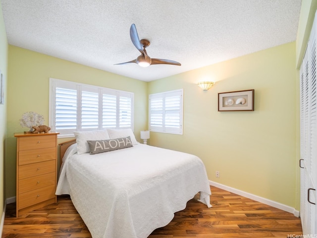 1586 Paukiki St, Kailua, HI 96734 - bedroom with wood finished floors, a ceiling fan, a textured ceiling, and a closet