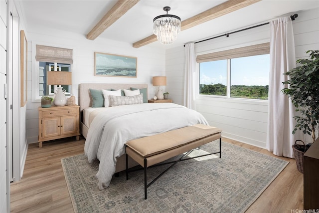 91-1101 Franklin D Roosevelt Ave Unit 335, Kapolei, HI 96707 - bedroom featuring light wood-style floors, a chandelier, and beamed ceiling
