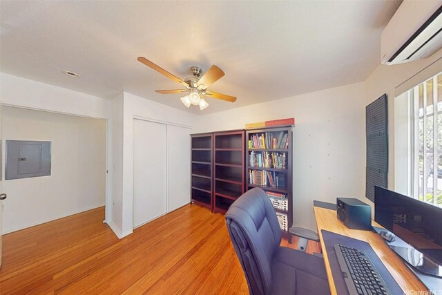 91-1105 Namahoe St Unit 2G, Kapolei, HI 96707 - office space featuring a wall mounted air conditioner, electric panel, a ceiling fan, and light wood finished floors