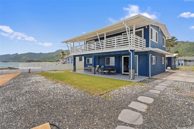 54-257 Kaipapau Loop, Hauula, HI 96717 - back of house with a balcony, a mountain view, and a patio area