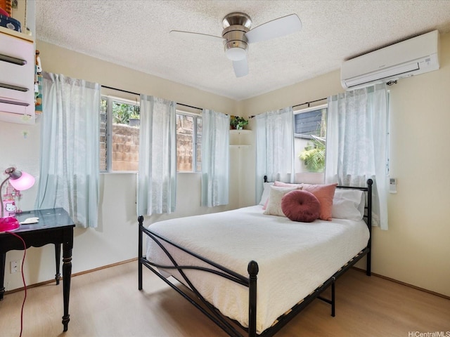 1549 Kanapuu Dr, Kailua, HI 96734 - bedroom with a wall mounted AC, a textured ceiling, wood finished floors, and a ceiling fan