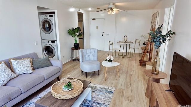 876 Curtis St Unit 2109, Honolulu, HI 96813 - living area featuring estacked washer and dryer, ceiling fan, and light wood-style flooring