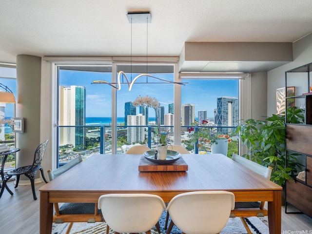 1288 Kapiolani Blvd Unit I2808, Honolulu, HI 96814 - dining space with wood finished floors and a city view