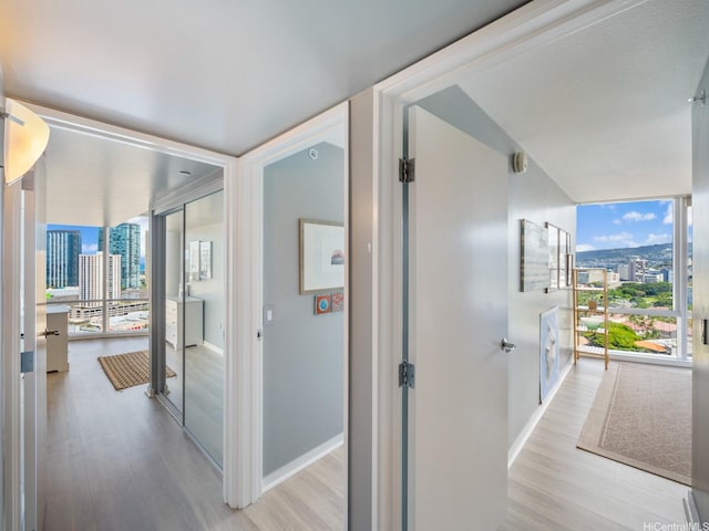 1288 Kapiolani Blvd Unit I2808, Honolulu, HI 96814 - hallway with light wood-style floors, healthy amount of natural light, expansive windows, and a view of city